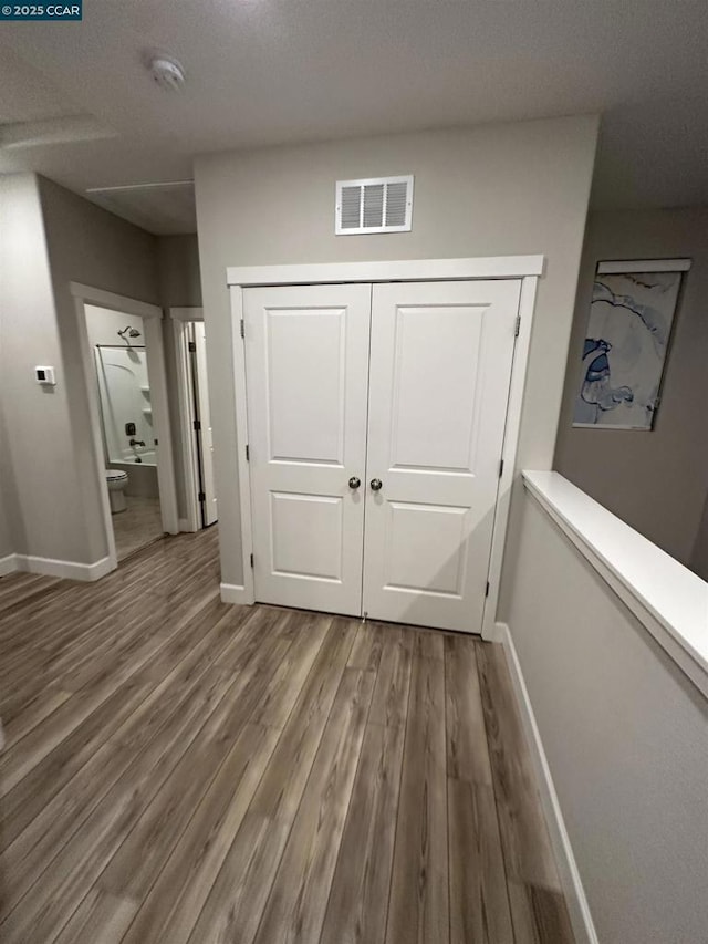 hallway featuring wood-type flooring