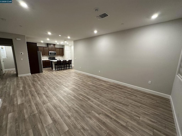 unfurnished living room with dark hardwood / wood-style flooring