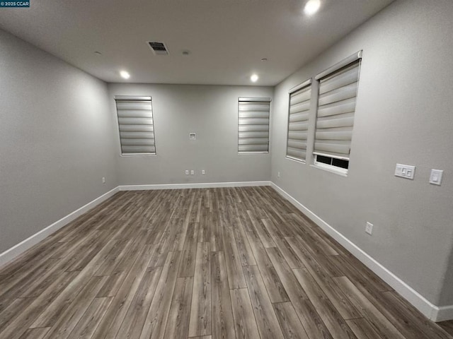 spare room with dark hardwood / wood-style floors