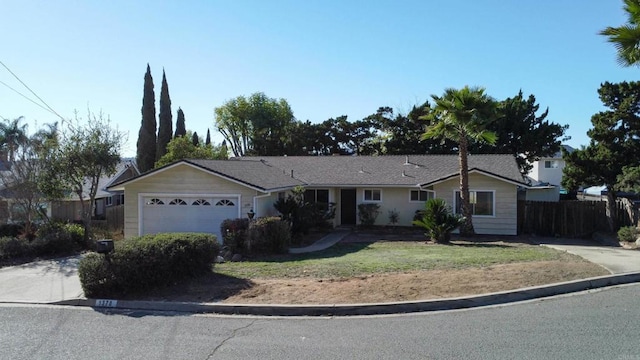 single story home featuring a garage and a front yard