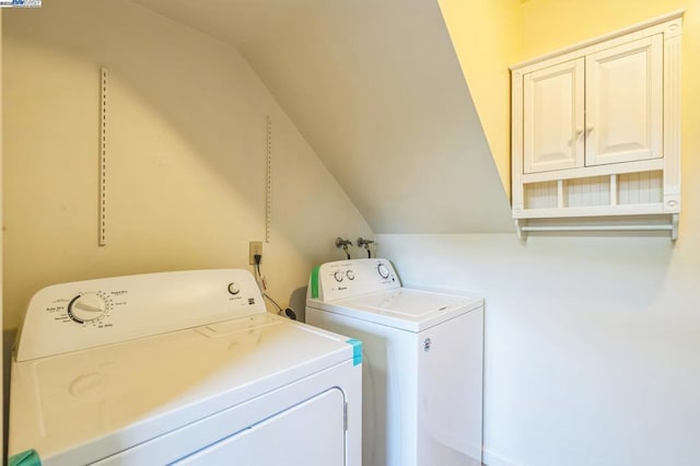 laundry room featuring cabinets and washer and clothes dryer