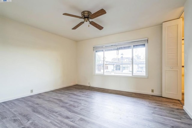 spare room with light hardwood / wood-style floors and ceiling fan