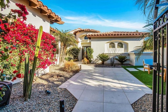 mediterranean / spanish-style home with a patio area