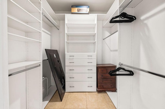 spacious closet with light tile patterned floors