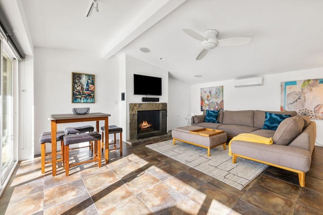 living room with a wall unit AC, ceiling fan, a healthy amount of sunlight, and a tiled fireplace