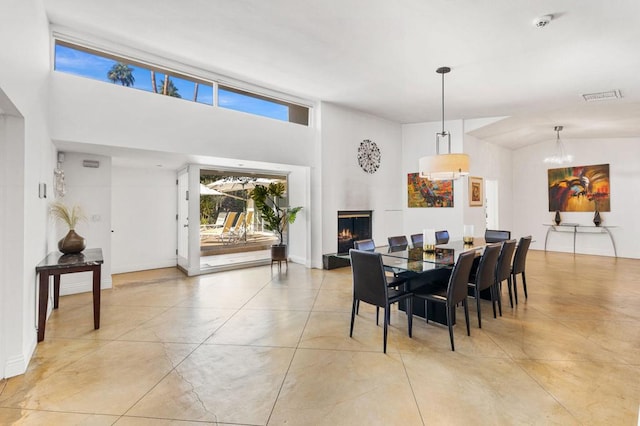 dining room featuring lofted ceiling and a notable chandelier