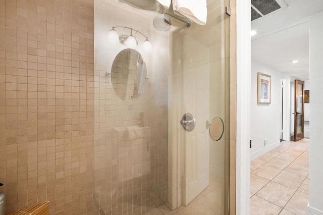 bathroom with walk in shower and tile patterned flooring