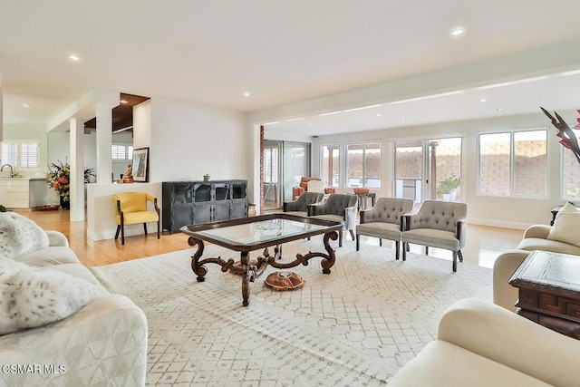 living room with light wood-type flooring and sink