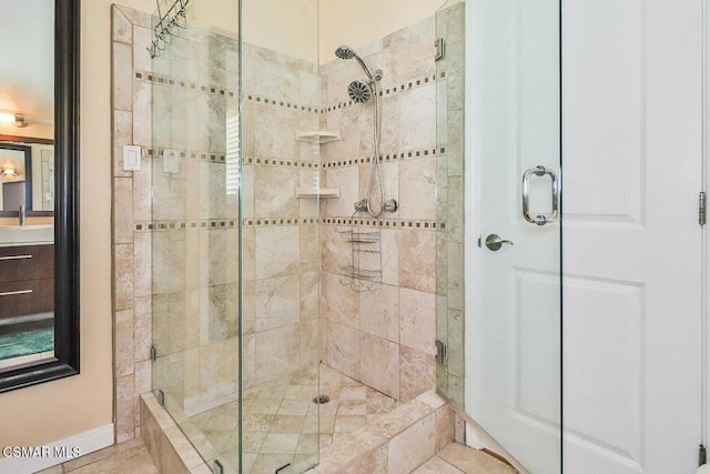 bathroom featuring tile patterned floors, vanity, and an enclosed shower