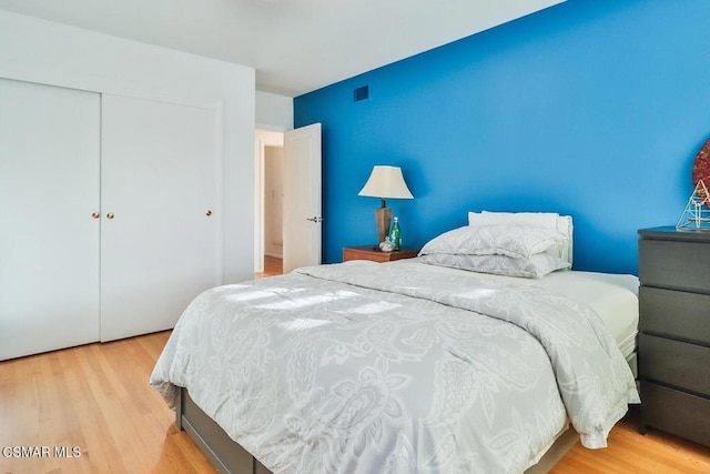 bedroom featuring light hardwood / wood-style flooring and a closet