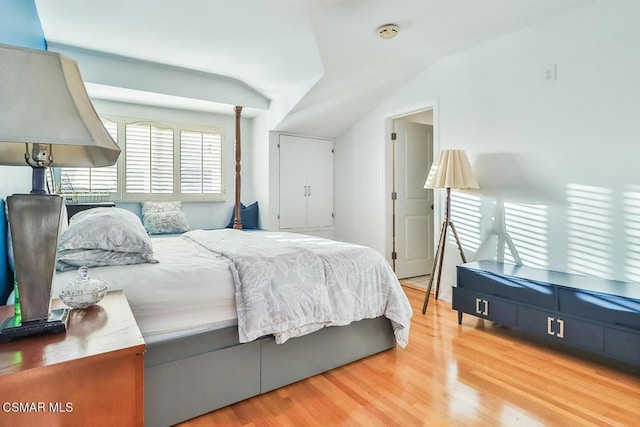 bedroom featuring wood-type flooring and vaulted ceiling