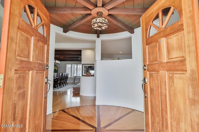 entrance foyer with beamed ceiling, wooden ceiling, and hardwood / wood-style flooring