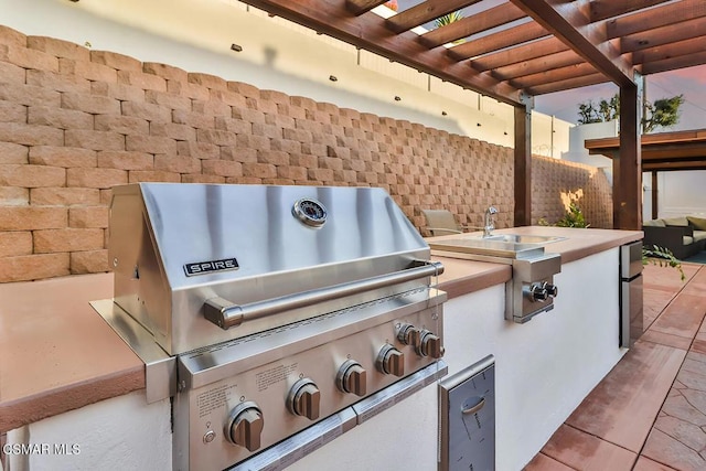 view of patio / terrace with a pergola, area for grilling, and grilling area