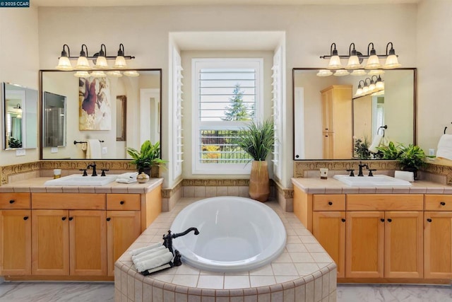 bathroom featuring vanity and tiled tub