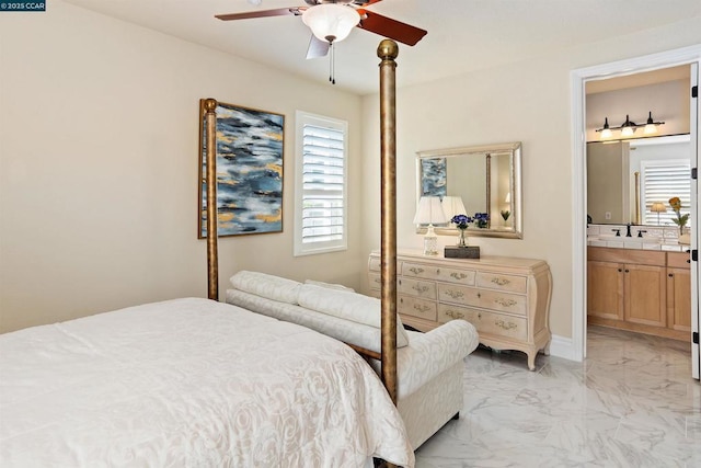 bedroom with ensuite bath, ceiling fan, and sink