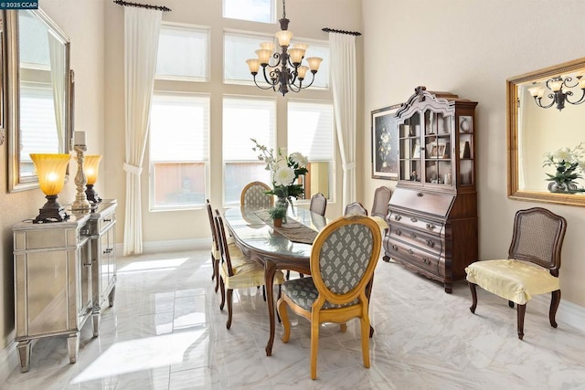 dining space with a wealth of natural light and a notable chandelier