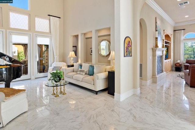 living room featuring a high ceiling and ornamental molding