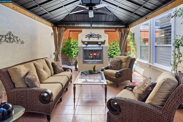 view of patio with an outdoor living space with a fireplace and a gazebo