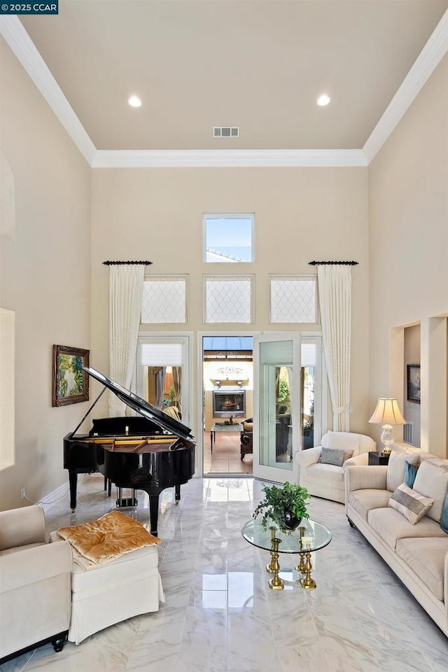 living room featuring a high ceiling and crown molding