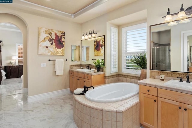 bathroom with vanity and separate shower and tub