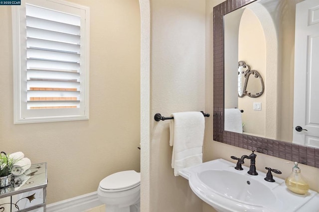 bathroom with toilet and sink