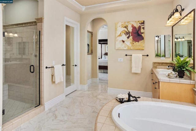 bathroom featuring separate shower and tub and vanity