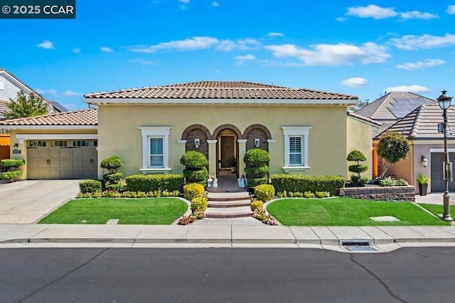 mediterranean / spanish house featuring a garage and a front lawn