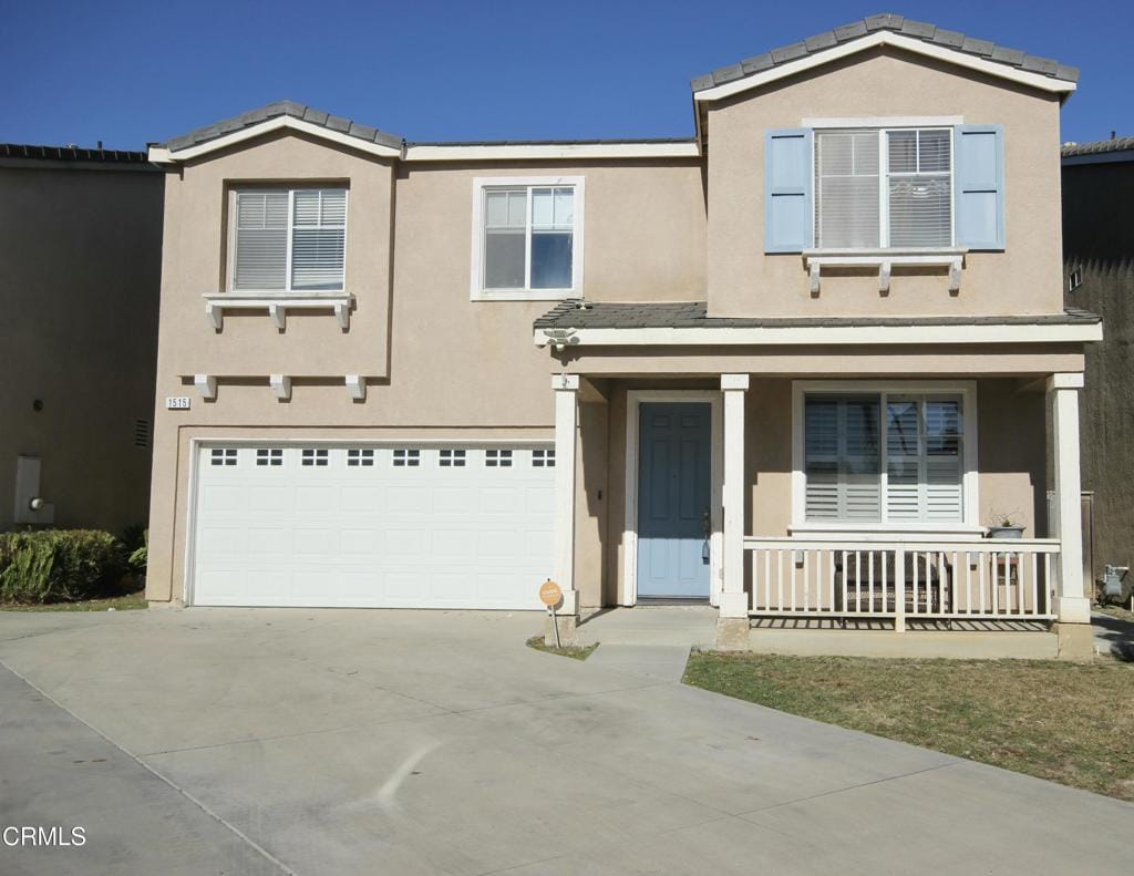 view of front of property featuring a porch and a garage