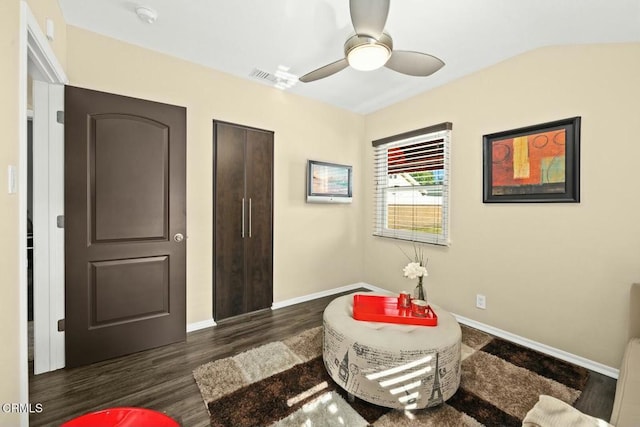 living area featuring ceiling fan and dark hardwood / wood-style floors