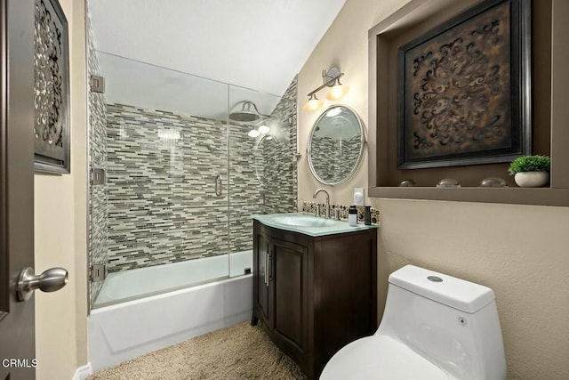 full bathroom featuring combined bath / shower with glass door, vanity, toilet, and lofted ceiling