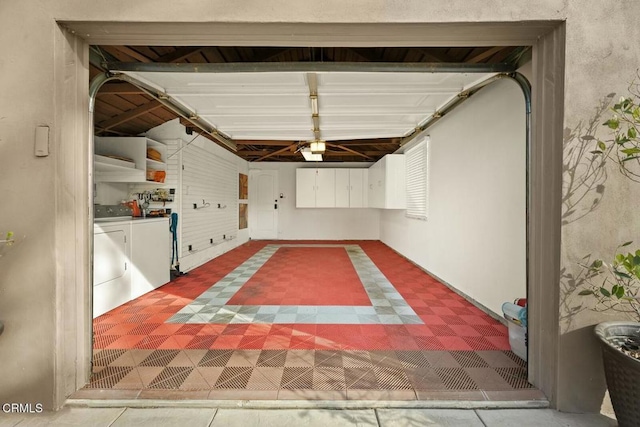 garage featuring washer and dryer and a garage door opener