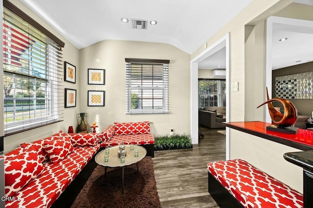 sitting room featuring dark hardwood / wood-style floors, lofted ceiling, and a wall mounted AC