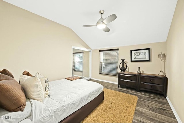 bedroom featuring dark hardwood / wood-style floors, vaulted ceiling, and ceiling fan