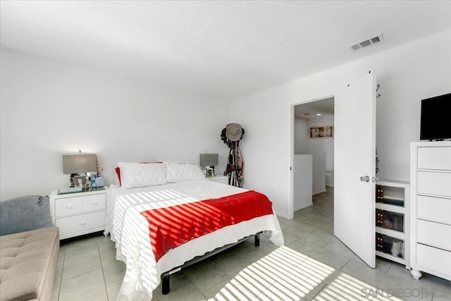 bedroom with light tile patterned floors