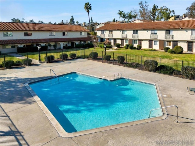 view of pool featuring a patio and a lawn