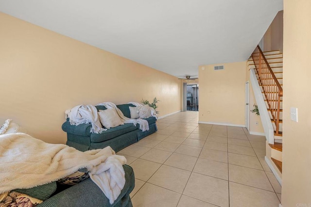 living room with light tile patterned flooring and ceiling fan