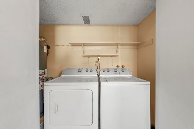 laundry area featuring independent washer and dryer and a textured ceiling