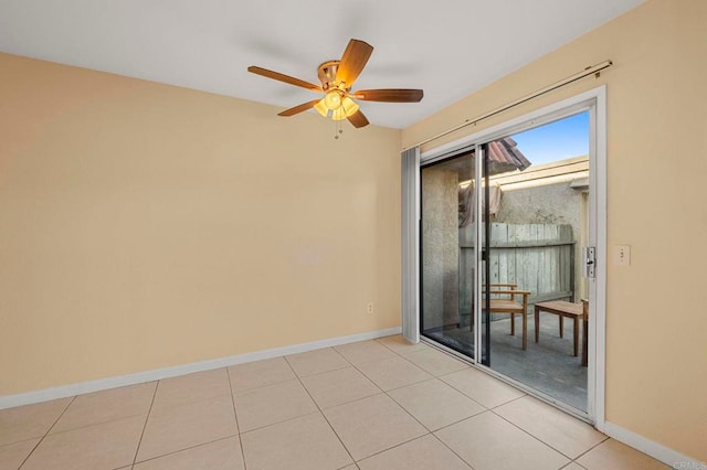 empty room featuring ceiling fan and light tile patterned floors