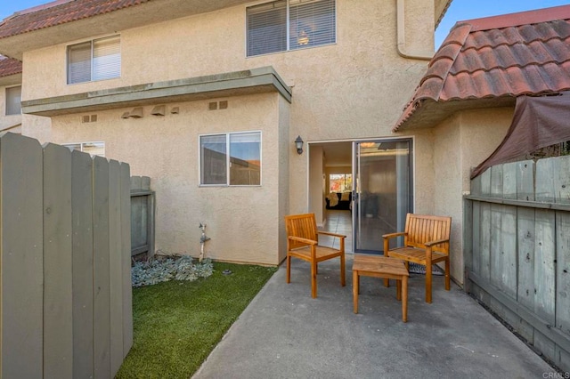 back of property with a patio