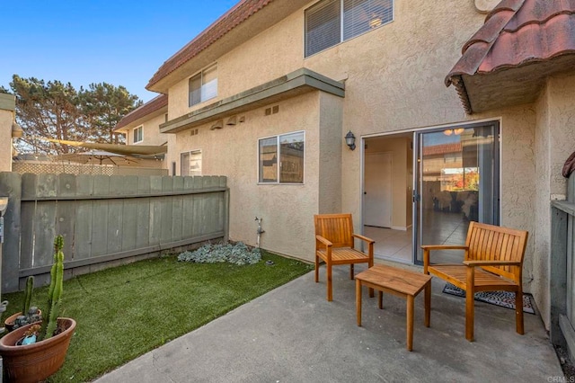 exterior space with a yard, fence, a patio, and stucco siding