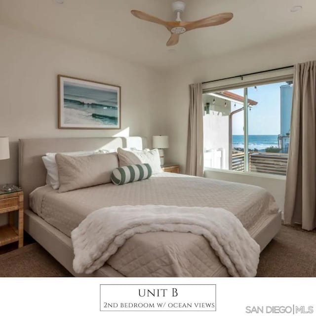 bedroom with carpet floors, a water view, and ceiling fan