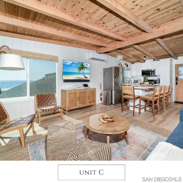 living room with light wood-type flooring, wood ceiling, a wall unit AC, beamed ceiling, and wood walls