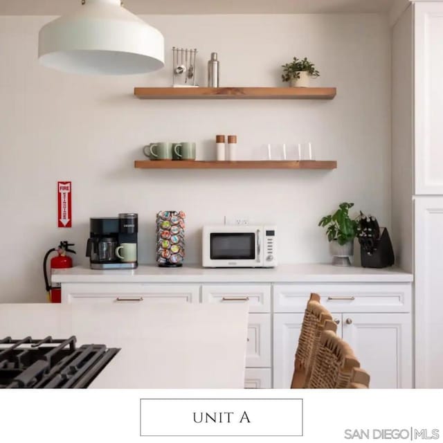 bar featuring white cabinets