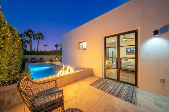 pool at dusk with a patio