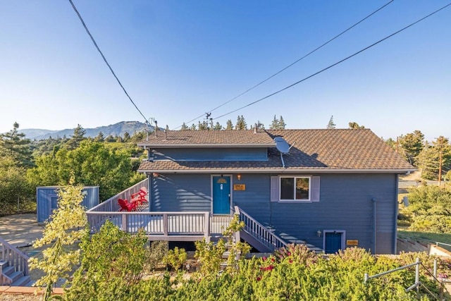 view of front of house featuring a deck with mountain view