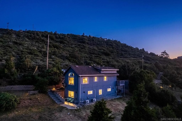 view of back house at dusk