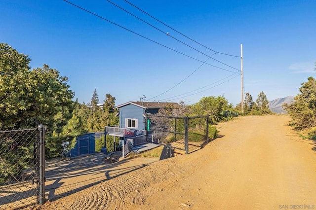 view of yard with a mountain view and a storage shed