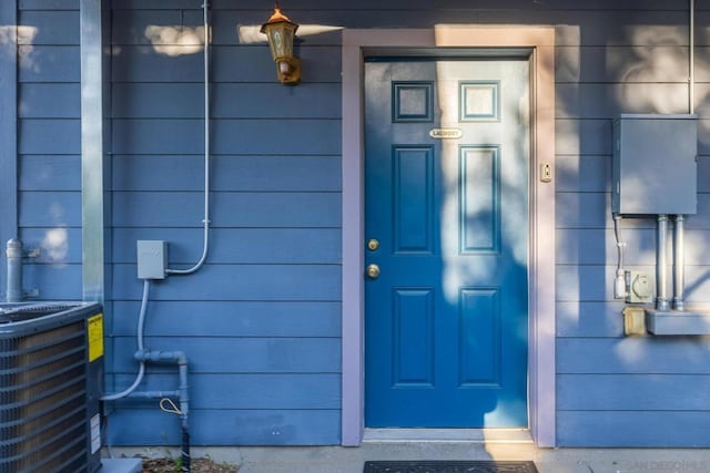 doorway to property featuring cooling unit