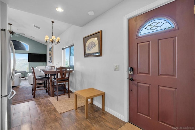 entrance foyer featuring ceiling fan with notable chandelier and lofted ceiling