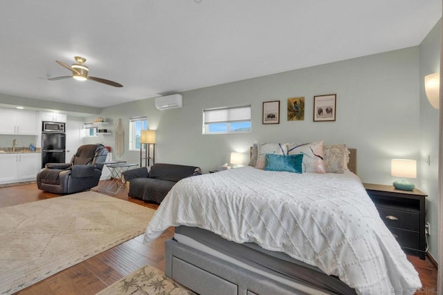 bedroom with a wall mounted air conditioner, dark hardwood / wood-style flooring, ceiling fan, and sink